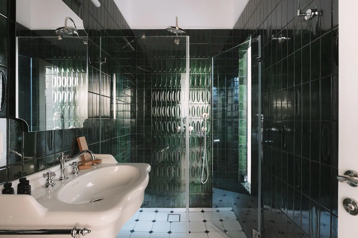 Une salle de bain privée aux carreaux vert sombre